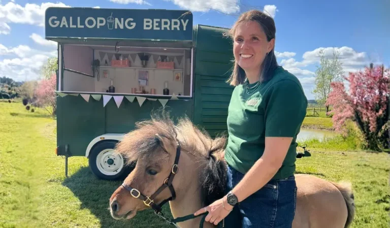 Catherine in front of the Galloping Berry with a pony.