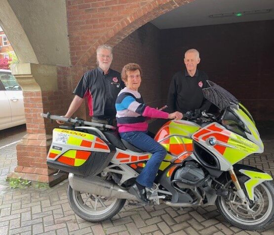 Blood Bikes visit the club and a service user tries out the bike for size! She poses for the camera with volunteers.