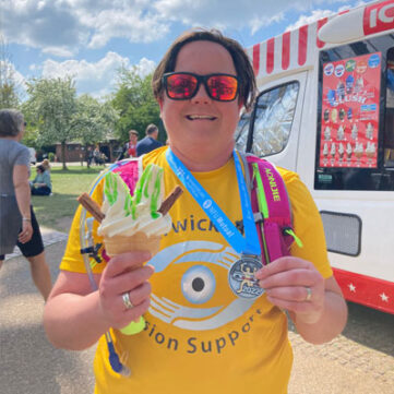 photo-of-a-fundraiser-holding-an-ice-cream-and-showing-off-medal
