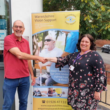 photo-of-a-man-and-woman-shaking-hands-at-a-warwickshire-vision-event