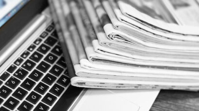 photograph-of-paper-articles-over-a-laptop-computer