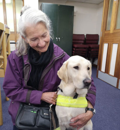 visually-impaired-woman-cuddling-a-guide-dog