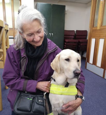 visually-impaired-woman-cuddling-a-guide-dog visually-impaired-woman-cuddling-a-guide-dog