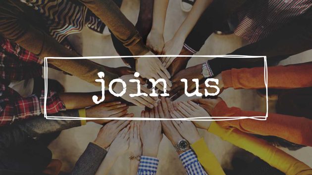 Hands piled into the middle of a circle with join us written on top Hands piled into the middle of a circle with join us written on top